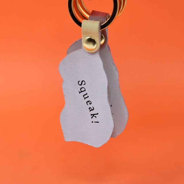 'Squeak!' The reverse of our three guinea pig leather keyings with a gold plated ring. Handmade in Cambridge using hot foil.