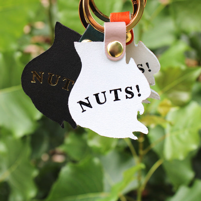 Three leather key rings in the shape of a squirrel featuring 'Nuts!' on the reverse.