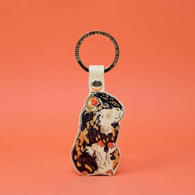 Cream coloured guinea pig leather keying with a gold plated ring. Handmade in Cambridge using hot foil.