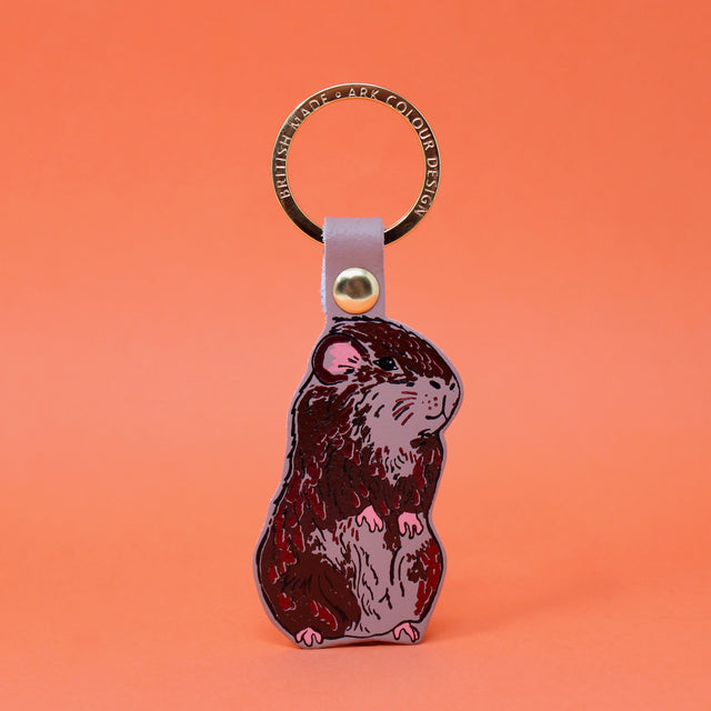 Nude coloured guinea pig leather keying with a gold plated ring. Handmade in Cambridge using hot foil.