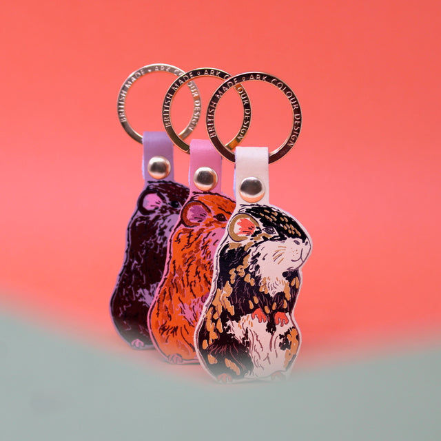 Three guinea pig leather keyings with a gold plated ring. Handmade in Cambridge using hot foil.